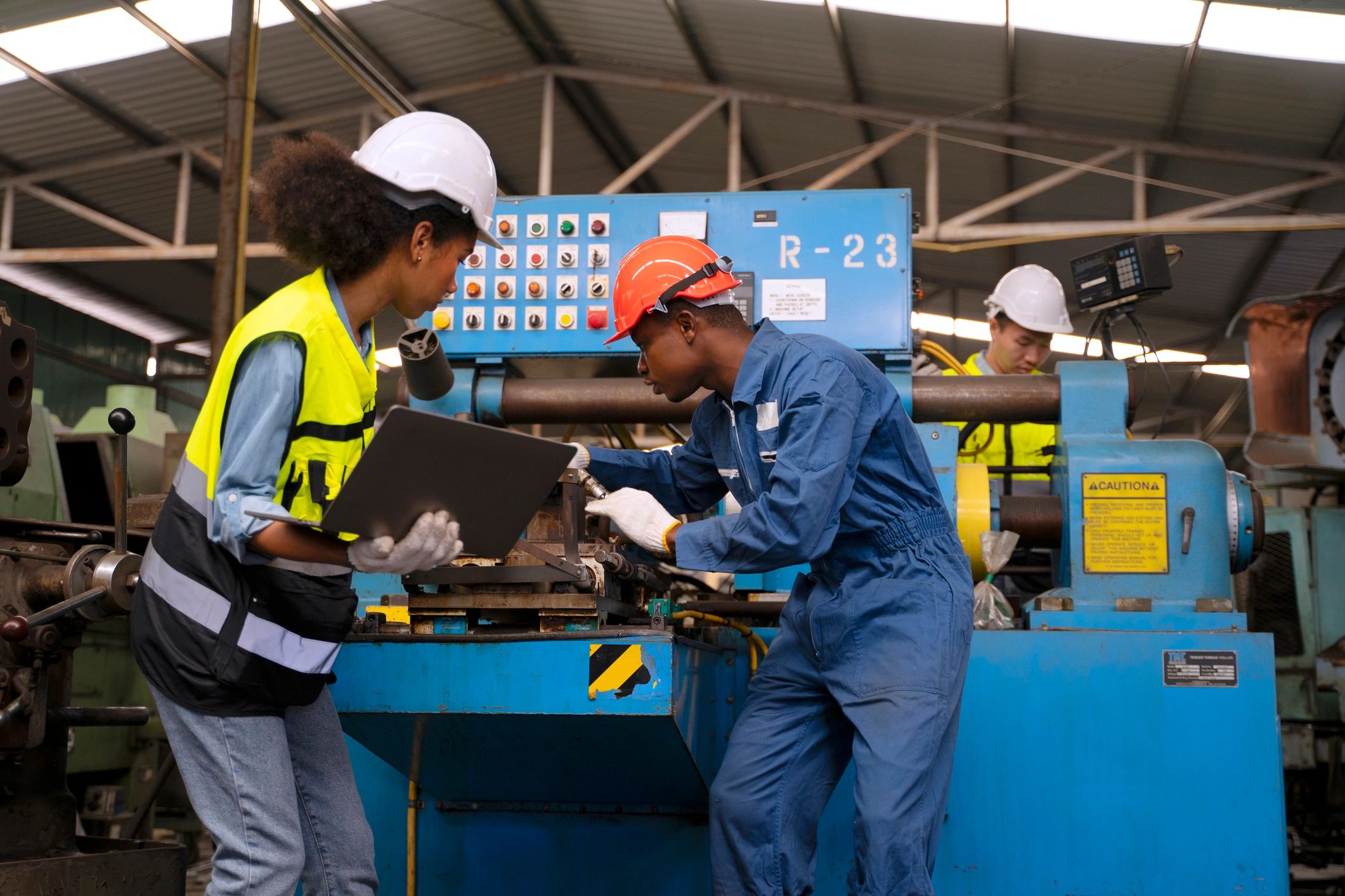 Industrial team members collaborating in a machinery facility